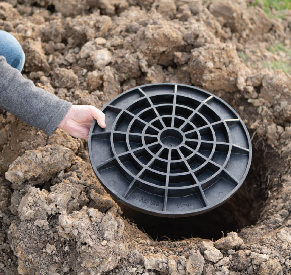 FootingPad® being dropped in hole on job site