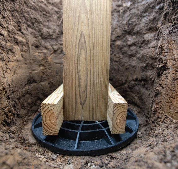 Wood uplift cleats fastened to wood column and placed on FootingPad®